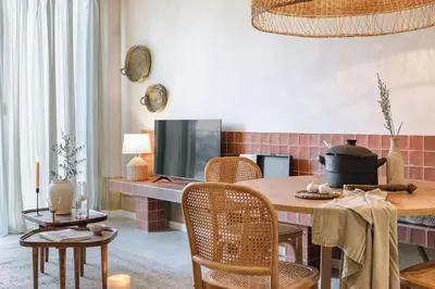 a wooden table with a candle and a chair at Algaba - 2 bedrooms in Eixample Esquerra in Barcelona