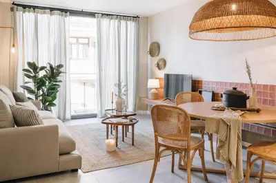 a living room with a table and chairs at Algaba - 2 bedrooms in Eixample Esquerra in Barcelona