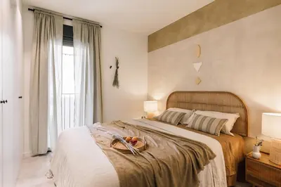 a living room with a table and chairs at Algaba - 2 bedrooms in Eixample Esquerra in Barcelona