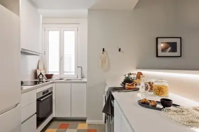 a living room with a couch and a tv at Rothko - 2 bedrooms and office in Eixample Dreta in Barcelona