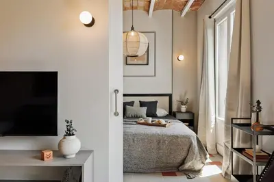 a living room with a couch and a table at Rothko - 2 bedrooms and office in Eixample Dreta in Barcelona