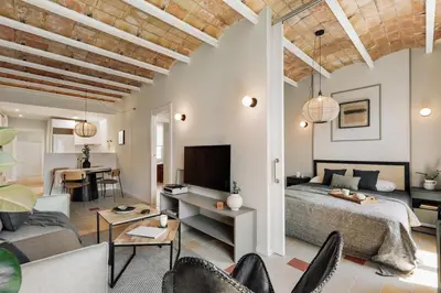 a hallway with a kitchen with white cabinets and a mirror at Rothko - 2 bedrooms and office in Eixample Dreta in Barcelona