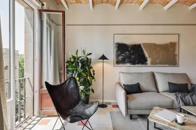 a bedroom with a bed and a living room at Rothko - 2 bedrooms and office in Eixample Dreta in Barcelona