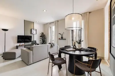 a living room with a table and chairs and a couch at Judd - 3 bedrooms and balcony in Eixample Esquerra in Barcelona