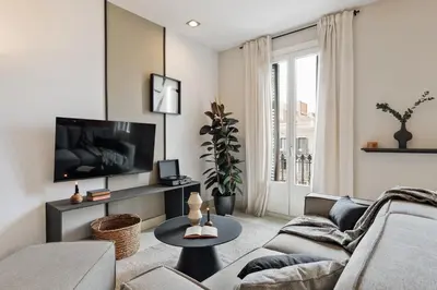 a living room with a couch and a table at Judd - 3 bedrooms and balcony in Eixample Esquerra in Barcelona