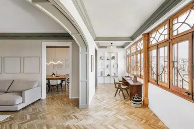 a bedroom with a large bed with a wooden headboard at Atrani - 3 bedroom in Eixample Dreta in Barcelona