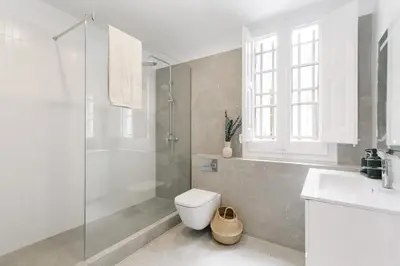 a bedroom with a bed and a wooden dresser in it at Atrani - 3 bedroom in Eixample Dreta in Barcelona