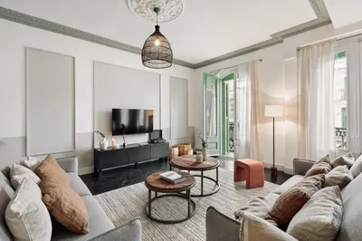 a living room with a couch and a table at Valls - 2 bedrooms and office in Gràcia in Barcelona