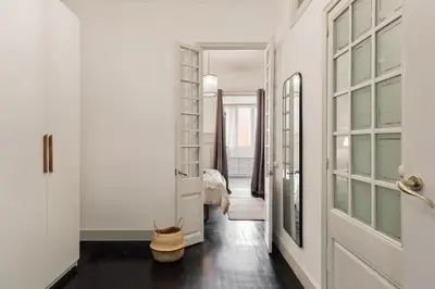 a living room with two couches and a table at Valls - 2 bedrooms and office in Gràcia in Barcelona