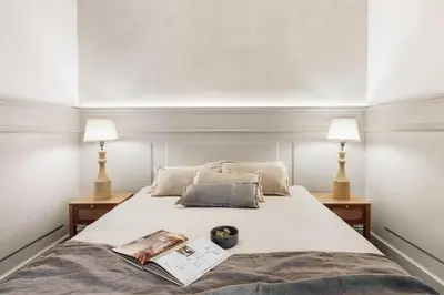 a kitchen with white cabinets and a wooden table at Valls - 2 bedrooms and office in Gràcia in Barcelona