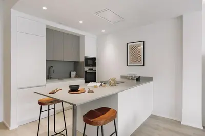 a bedroom with a bed in a white room at Grotta - 3 bedrooms in Sant Gervasi in Barcelona