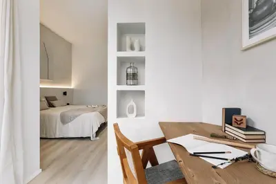 a kitchen and dining room with white walls and wooden ceilings at Grotta - 3 bedrooms in Sant Gervasi in Barcelona