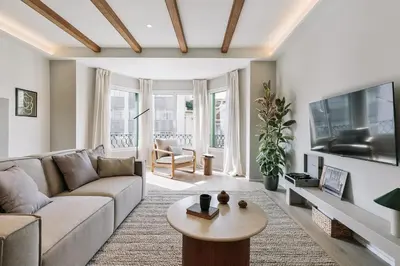 a living room with a couch and a table at Grotta - 3 bedrooms in Sant Gervasi in Barcelona