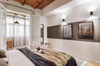 a bedroom with a large bed and a window at Balai - 2 bedrooms in Eixample Dreta in Barcelona