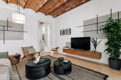 a living room with a couch and a chandelier at Balai - 2 bedrooms in Eixample Dreta in Barcelona