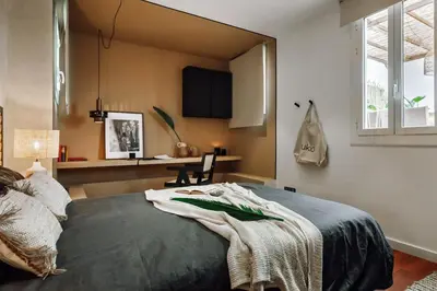 a bedroom with a bed and a desk and a window at Kambove - 2 bedrooms in Eixample Dreta in Barcelona