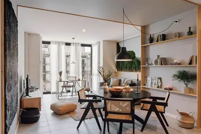 a living room with a table and chairs at Aneto - 3 bedrooms in Eixample Esquerra in Barcelona