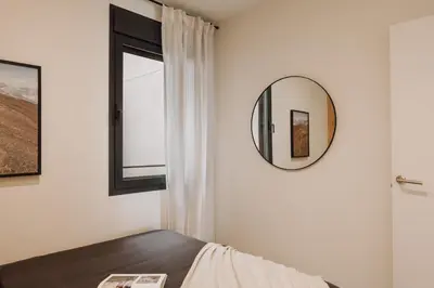 a hallway with a mirror and a dining room at Aneto - 3 bedrooms in Eixample Esquerra in Barcelona