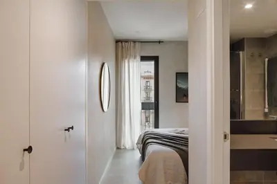 a bedroom with a bed and a large closet at Aneto - 3 bedrooms in Eixample Esquerra in Barcelona