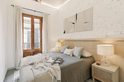 a white kitchen with white cabinets and a rug at Maiori - 2 bedrooms and terrace in Sant Gervasi in Barcelona