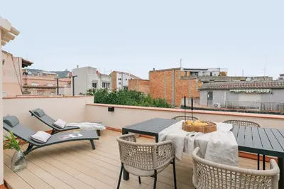a patio with a table and chairs on a balcony at Maiori - 2 bedrooms and terrace in Sant Gervasi in Barcelona