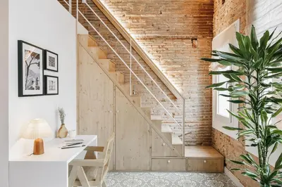 a living room with a couch and a kitchen at Maiori - 2 bedrooms and terrace in Sant Gervasi in Barcelona