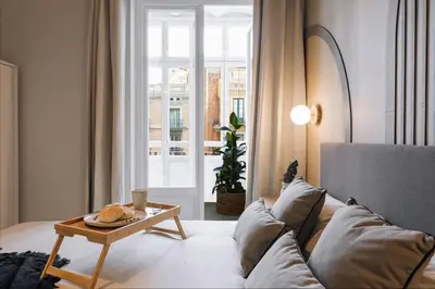 a kitchen with white cabinets and a dishwasher at Senahu - 2 bedrooms and office in Eixample Dreta in Barcelona