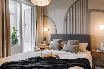 a dining room with a table and some windows at Senahu - 2 bedrooms and office in Eixample Dreta in Barcelona