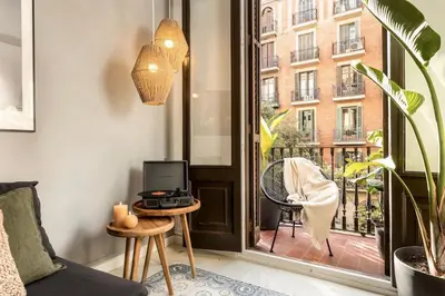 a dining room with a wooden table and chairs at Tambo - 2 bedrooms in Eixample Esquerra in Barcelona