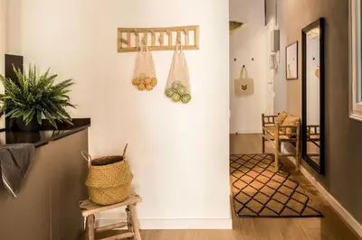 a bathroom with a sink and mirrors on the wall at Tambo - 2 bedrooms in Eixample Esquerra in Barcelona