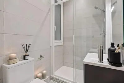 a living room with a couch and a tv at Dorria - 3 bedrooms in Eixample Dreta in Barcelona