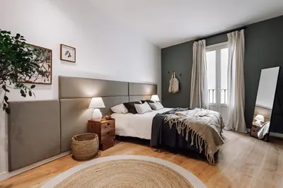 a bedroom with a bed and a bathroom with a shower at Arjona - 3 bedrooms in Eixample Dreta in Barcelona