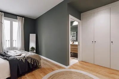 a bedroom with a bed and a large window at Arjona - 3 bedrooms in Eixample Dreta in Barcelona