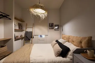 a kitchen with white cabinets and a sink at Muari - 2 bedrooms in Eixample Esquerra in Barcelona