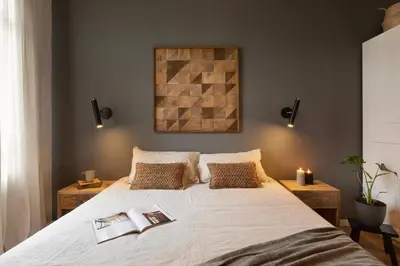 a bedroom with a large bed and a chandelier at Muari - 2 bedrooms in Eixample Esquerra in Barcelona