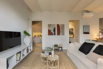 a living room with a table and chairs at Muari - 2 bedrooms in Eixample Esquerra in Barcelona