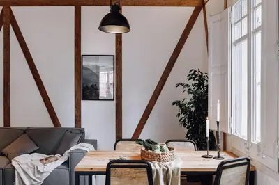 a dining room with a wooden table and a kitchen at Ossau - 3 bedrooms in Sant Gervasi in Barcelona