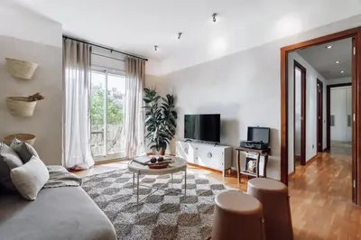 a bedroom with a large bed with a table in it at Cazalla - 2 bedrooms and office in Gràcia in Barcelona
