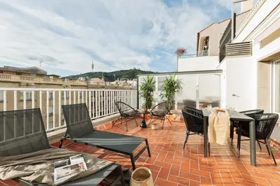 a patio with chairs and a table on a balcony at Banchina - 1 bedroom and terrace in Sant Gervasi in Barcelona