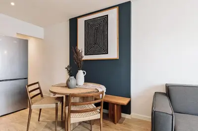a kitchen and living room with a table and chairs at Banchina - 1 bedroom and terrace in Sant Gervasi in Barcelona