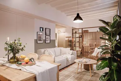 a bedroom with two beds and a table with a candle at Ubrique - Studio in El Born in Barcelona