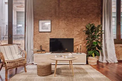 a bedroom with a large bed and a large window at Ubrique - Studio in El Born in Barcelona