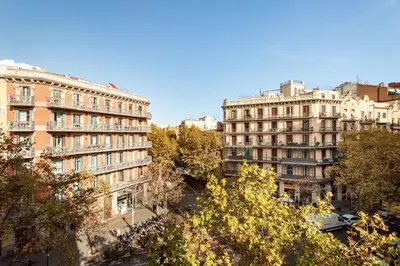 a kitchen with wooden cabinets and a washer and dryer at Aino - 2 bedrooms and balcony in Eixample Esquerra in Barcelona