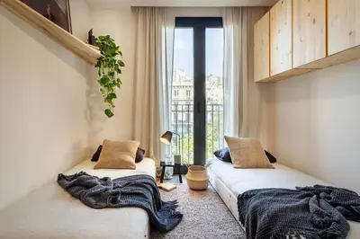 a bedroom with a bed with a magazine on it at Aino - 2 bedrooms and balcony in Eixample Esquerra in Barcelona