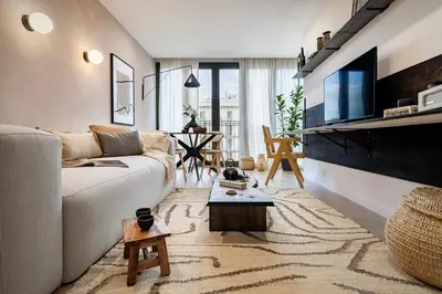 a living room with a table and chairs and a couch at Aino - 2 bedrooms and balcony in Eixample Esquerra in Barcelona