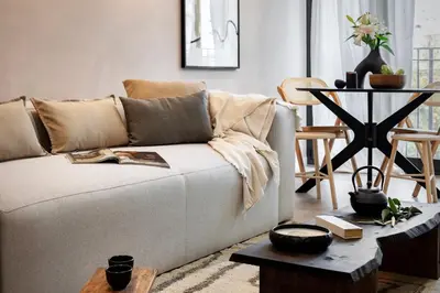 a balcony with a table and chairs and a building at Aino - 2 bedrooms and balcony in Eixample Esquerra in Barcelona