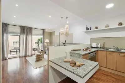 two chairs and a table in a room at Nerano - 2 bedrooms and terrace in Gràcia in Barcelona