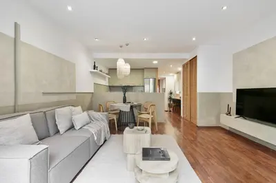 a kitchen with marble counter tops and wooden cabinets at Nerano - 2 bedrooms and terrace in Gràcia in Barcelona