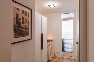 a hallway with white walls and a mirror at Nava - 3 bedrooms in Sant Gervasi in Barcelona