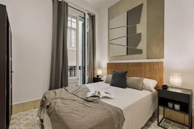 a living room with a table and a dining room at Uru - 2 bedrooms and balcony in Vila de Gràcia in Barcelona